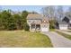 Charming two-story home features a manicured lawn and attached two-car garage at 50 Yelverton Ct, Holly Springs, NC 27540