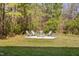 This beautiful backyard has a fire pit surrounded by trees, perfect for outdoor gatherings at 50 Yelverton Ct, Holly Springs, NC 27540