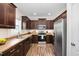 Updated kitchen featuring stainless steel appliances, dark wood cabinets and ample counter space at 50 Yelverton Ct, Holly Springs, NC 27540
