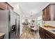 Open concept kitchen with view into living room and dining area, and stainless steel refrigerator at 50 Yelverton Ct, Holly Springs, NC 27540