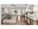 Open-concept living room with hardwood floors, neutral walls, dining area, and natural light at 50 Yelverton Ct, Holly Springs, NC 27540