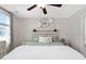 This bright main bedroom features a wood-paneled headboard and decorative wall art at 50 Yelverton Ct, Holly Springs, NC 27540