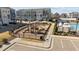 Community playground featuring modern equipment in a safe, fenced area adjacent to a pool and townhomes at 5200 Invention Way, Raleigh, NC 27616