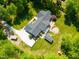 Expansive property featuring lush landscaping, a large driveway, a rear patio, and mature tree coverage at 5313 Edington Ln, Raleigh, NC 27604