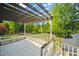 Inviting back deck with a pergola provides a relaxing space overlooking the backyard and lush green scenery at 5313 Edington Ln, Raleigh, NC 27604