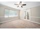 Bright bedroom featuring a ceiling fan, neutral walls, carpet flooring, and large window at 5313 Edington Ln, Raleigh, NC 27604