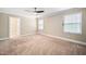Bright bedroom featuring a ceiling fan, carpet flooring, neutral walls, and a large window at 5313 Edington Ln, Raleigh, NC 27604