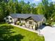 Well-maintained single-story home with a lush green lawn, mature trees, and an attached two-car garage at 5313 Edington Ln, Raleigh, NC 27604