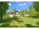 Ranch-style home showcasing its manicured lawn and mature trees in a serene, suburban setting at 5313 Edington Ln, Raleigh, NC 27604