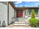 Elegant front entrance with a red door, brick steps, and manicured landscaping for added charm at 5313 Edington Ln, Raleigh, NC 27604