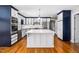 Modern kitchen with center island, stainless steel appliances, and ample cabinet space at 5313 Edington Ln, Raleigh, NC 27604