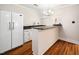 Cozy kitchenette featuring a breakfast bar, mini fridge, and convenient sink area at 5313 Edington Ln, Raleigh, NC 27604