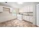 Practical laundry room featuring wainscotting, washer, dryer, sink and storage at 5313 Edington Ln, Raleigh, NC 27604