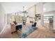 Inviting living room featuring high ceilings, a cozy fireplace, built-in shelving, and large windows at 5313 Edington Ln, Raleigh, NC 27604