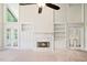 Elegant living room with a fireplace, built-in cabinets, and French doors at 5313 Edington Ln, Raleigh, NC 27604