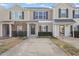 Charming townhouse with a stone facade and covered entrance to provide an inviting curb appeal at 5340 Big Bass Dr, Raleigh, NC 27610