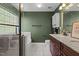Luxurious bathroom featuring a glass-enclosed shower, soaking tub, and elegant vanity with granite countertops at 5405 Seaspray Ln, Raleigh, NC 27610