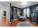 Comfortable bedroom featuring a cozy seating area, large window, and stylish dark blue walls at 5405 Seaspray Ln, Raleigh, NC 27610
