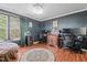Stylish bedroom with dark walls, modern decor, and an abundance of natural light from the window at 5405 Seaspray Ln, Raleigh, NC 27610