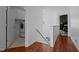 Upstairs hallway with laundry closet, wood floors and a view of the bedroom at 5405 Seaspray Ln, Raleigh, NC 27610