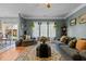 Comfortable living room featuring a large window, plush seating, and a decorative rug at 5405 Seaspray Ln, Raleigh, NC 27610