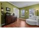 Inviting living area with green walls, white trim, hardwood floors, and comfortable seating at 5405 Seaspray Ln, Raleigh, NC 27610