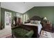 A spacious main bedroom with wood furnishings, bench, and carpeted floors for comfort and style at 5405 Seaspray Ln, Raleigh, NC 27610