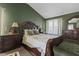 A spacious main bedroom with wood furnishings, bench, and carpeted floors for comfort and style at 5405 Seaspray Ln, Raleigh, NC 27610