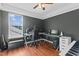 Comfortable office space with a ceiling fan, modern desk, and hardwood floors, perfect for a productive work environment at 5405 Seaspray Ln, Raleigh, NC 27610