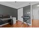 Functional office space featuring a glass desk, closet, and keyboard setup for work and creative endeavors at 5405 Seaspray Ln, Raleigh, NC 27610