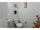 Neat powder room with a small vanity sink, toilet, and neutral-colored walls at 5405 Seaspray Ln, Raleigh, NC 27610