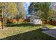 The home has a shed in the back with a lawn, landscaping, and a wood fence at 5405 Seaspray Ln, Raleigh, NC 27610