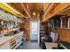 Inside the shed, find ample storage with shelves, a work area, and a door to the backyard at 5405 Seaspray Ln, Raleigh, NC 27610