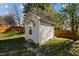 The house includes a backyard shed with a door, steps, and a small awning above the door at 5405 Seaspray Ln, Raleigh, NC 27610
