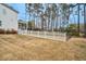 Fenced-in backyard with white picket fence and view of home's screened-in porch at 5450 Hunter Hill Rd, Rocky Mount, NC 27804