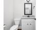 Bathroom featuring tile countertop, neutral paint, toilet and modern lighting at 5450 Hunter Hill Rd, Rocky Mount, NC 27804