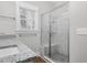 Bright bathroom featuring a glass shower and marble tile surround at 5450 Hunter Hill Rd, Rocky Mount, NC 27804