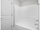 Bright bathroom featuring white tiled shower/tub and neutral paint at 5450 Hunter Hill Rd, Rocky Mount, NC 27804