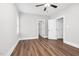 An empty bedroom featuring new blinds, ceiling fan, and vinyl flooring at 5450 Hunter Hill Rd, Rocky Mount, NC 27804