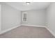 Empty bedroom with carpet flooring and a window providing natural light at 5450 Hunter Hill Rd, Rocky Mount, NC 27804