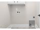 Laundry room showcasing washer and dryer hookups, plus overhead cabinetry at 5450 Hunter Hill Rd, Rocky Mount, NC 27804