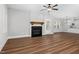 Living room featuring a fireplace, ceiling fan, and hardwood floors at 5450 Hunter Hill Rd, Rocky Mount, NC 27804