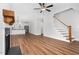 Living room with hardwood floors, staircase and view into kitchen at 5450 Hunter Hill Rd, Rocky Mount, NC 27804