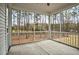 View of large screened porch with concrete floors and backyard bordered by woods at 5450 Hunter Hill Rd, Rocky Mount, NC 27804