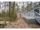 Backyard showcasing a deck, detached garage, and exterior details, enhancing the property's appeal at 602 N Mineral Springs Rd, Durham, NC 27703