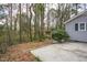 View of the private backyard with a patio area and mature trees providing shade and seclusion at 602 N Mineral Springs Rd, Durham, NC 27703
