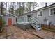 Rear view of home with a deck and detached garage, showing exterior details and outdoor living space at 602 N Mineral Springs Rd, Durham, NC 27703
