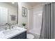 Bathroom featuring a bath, shower, sink, toilet, and a vanity with gray accents at 602 N Mineral Springs Rd, Durham, NC 27703