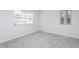 Bedroom with carpet, two windows letting in natural light, and neutral colors at 602 N Mineral Springs Rd, Durham, NC 27703