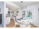 Bright dining area open to the kitchen with modern light fixture at 602 N Mineral Springs Rd, Durham, NC 27703